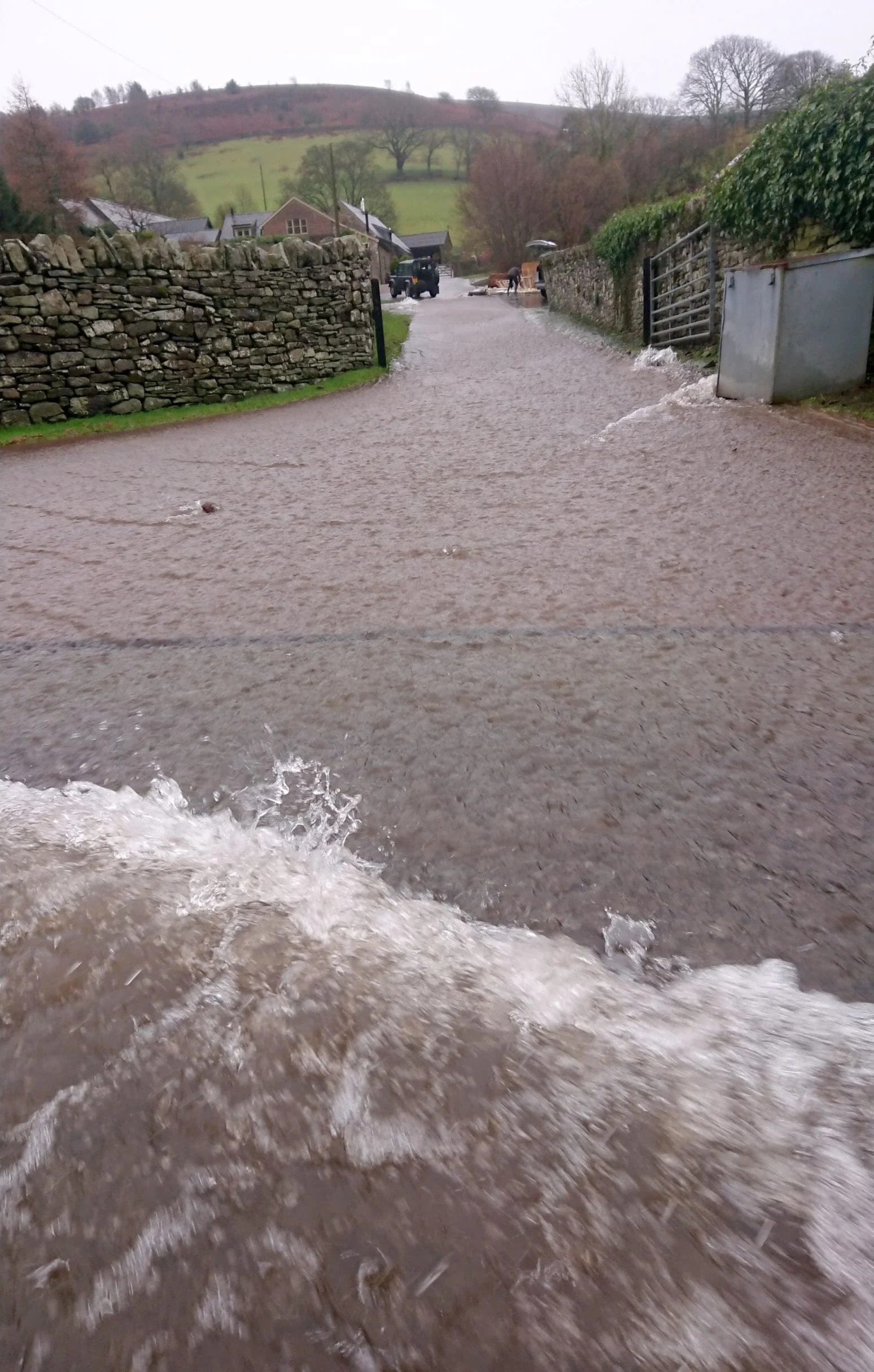 Rainfall running quickly off a hill, down a farm road and straight into the Usk. Better soil infiltration would reduce the volume and speed of runoff, helping towns further down the Usk Valley.